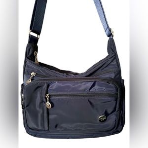 Jielshi Light Life Nylon Travel Bag. Tons of pockets and weighs less than 1 lb!